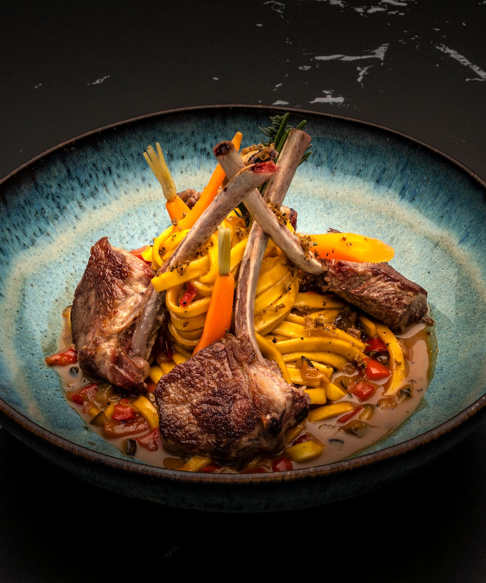 a bowl of food on a black surface