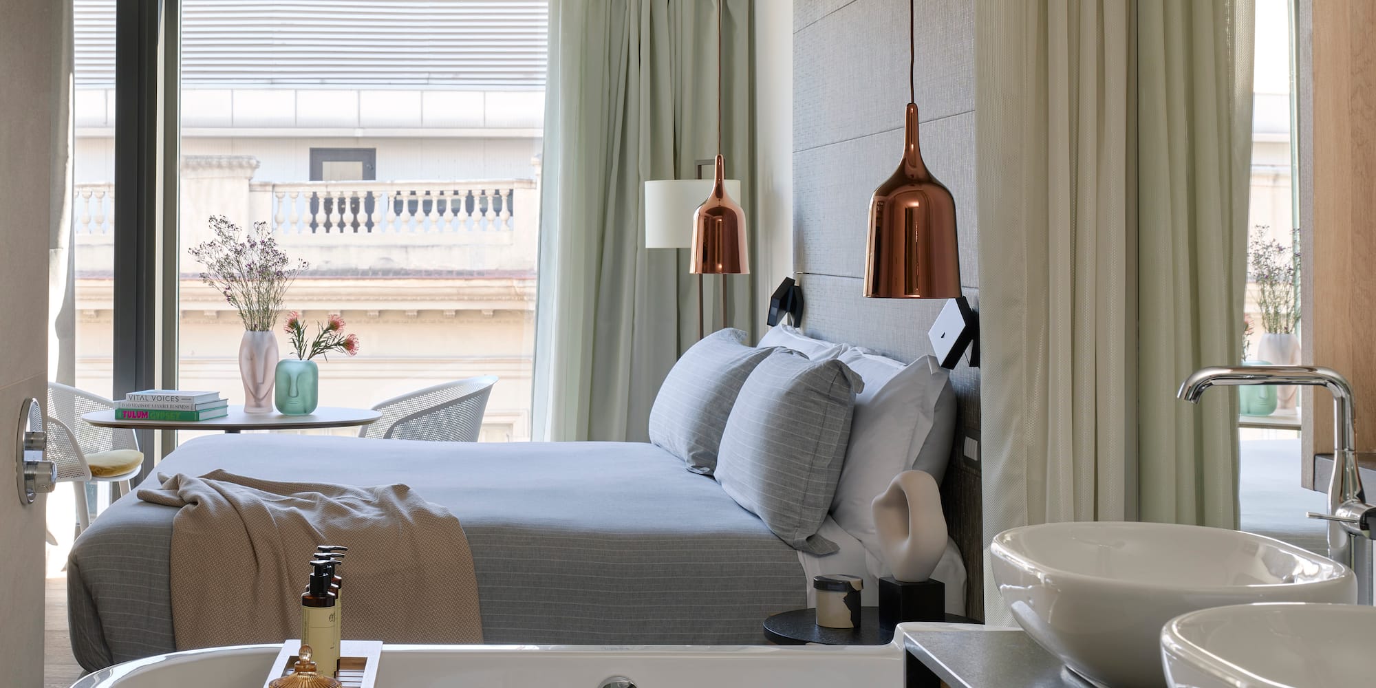 a bedroom with a bathtub and a bed