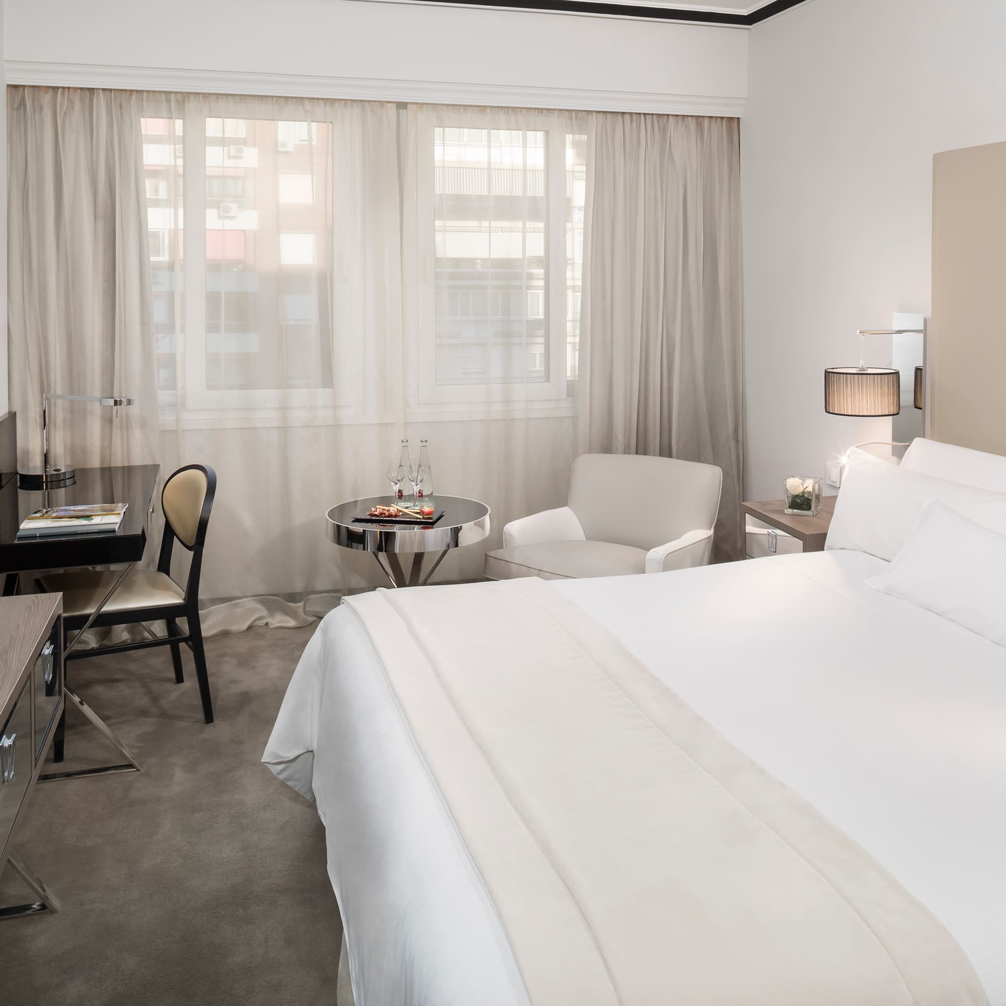 a bedroom with a desk and a bed