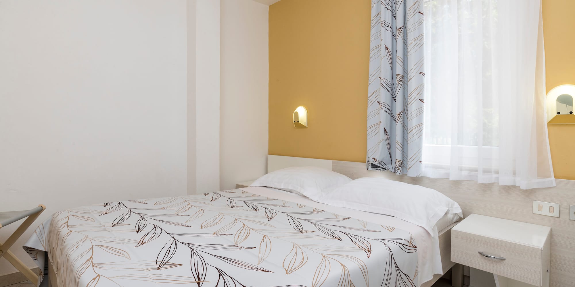 a bed with a white and brown blanket