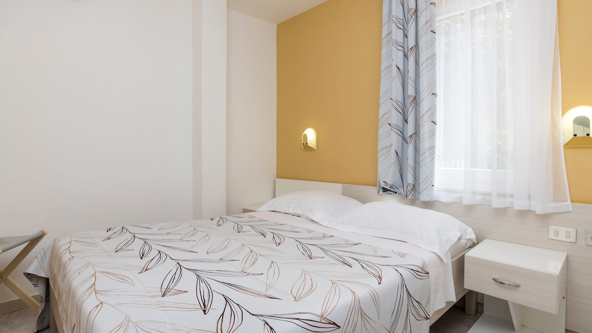 a bed with a white and brown blanket