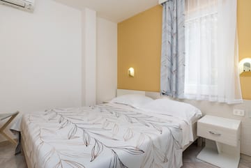 a bed with a white and brown blanket