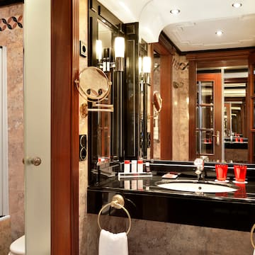 a bathroom with a black countertop and a mirror