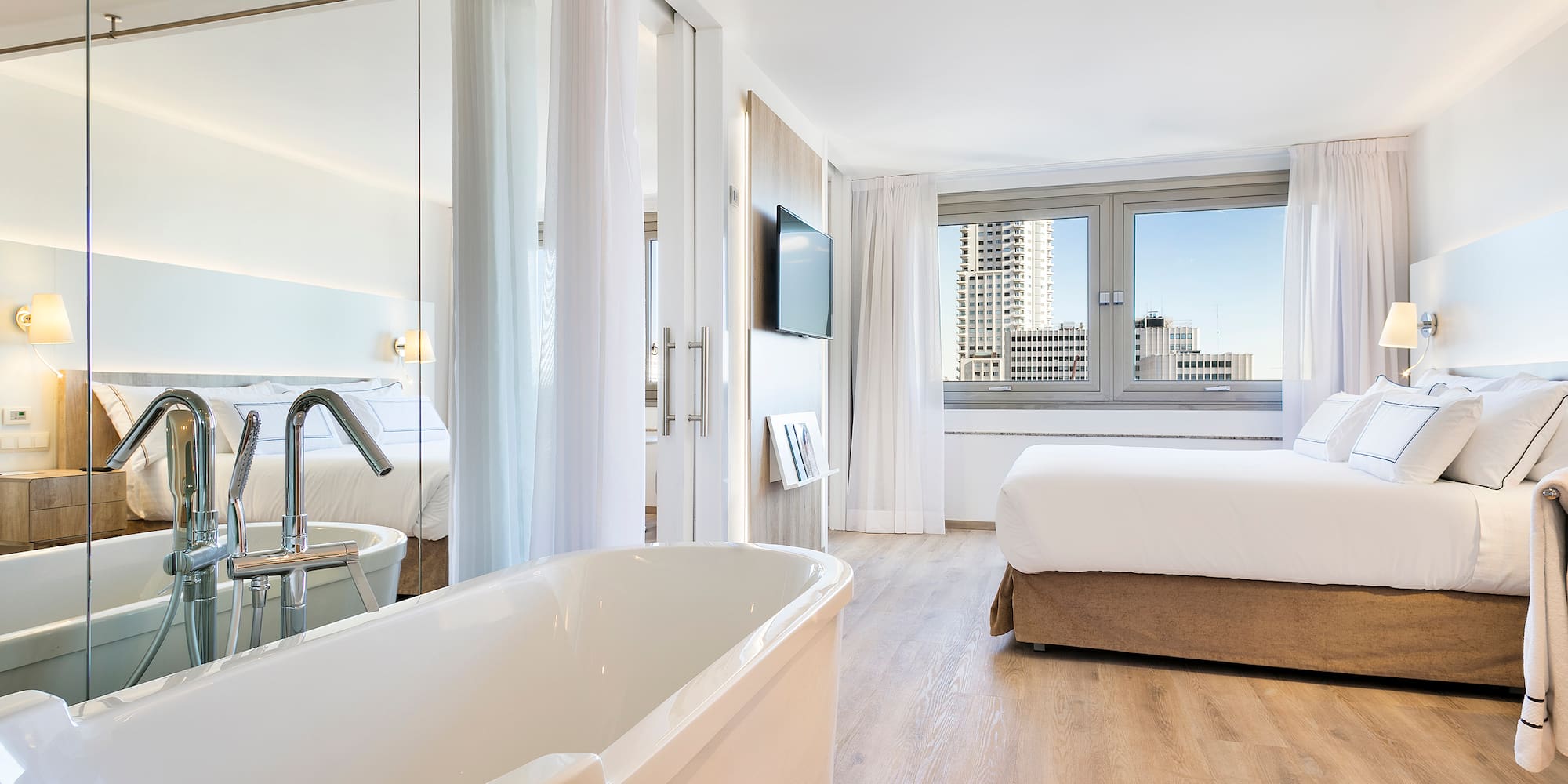 a room with a bed and a bathtub