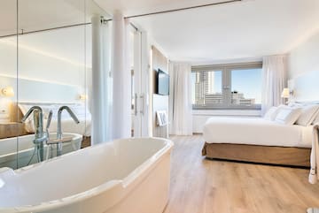 a room with a bed and a bathtub