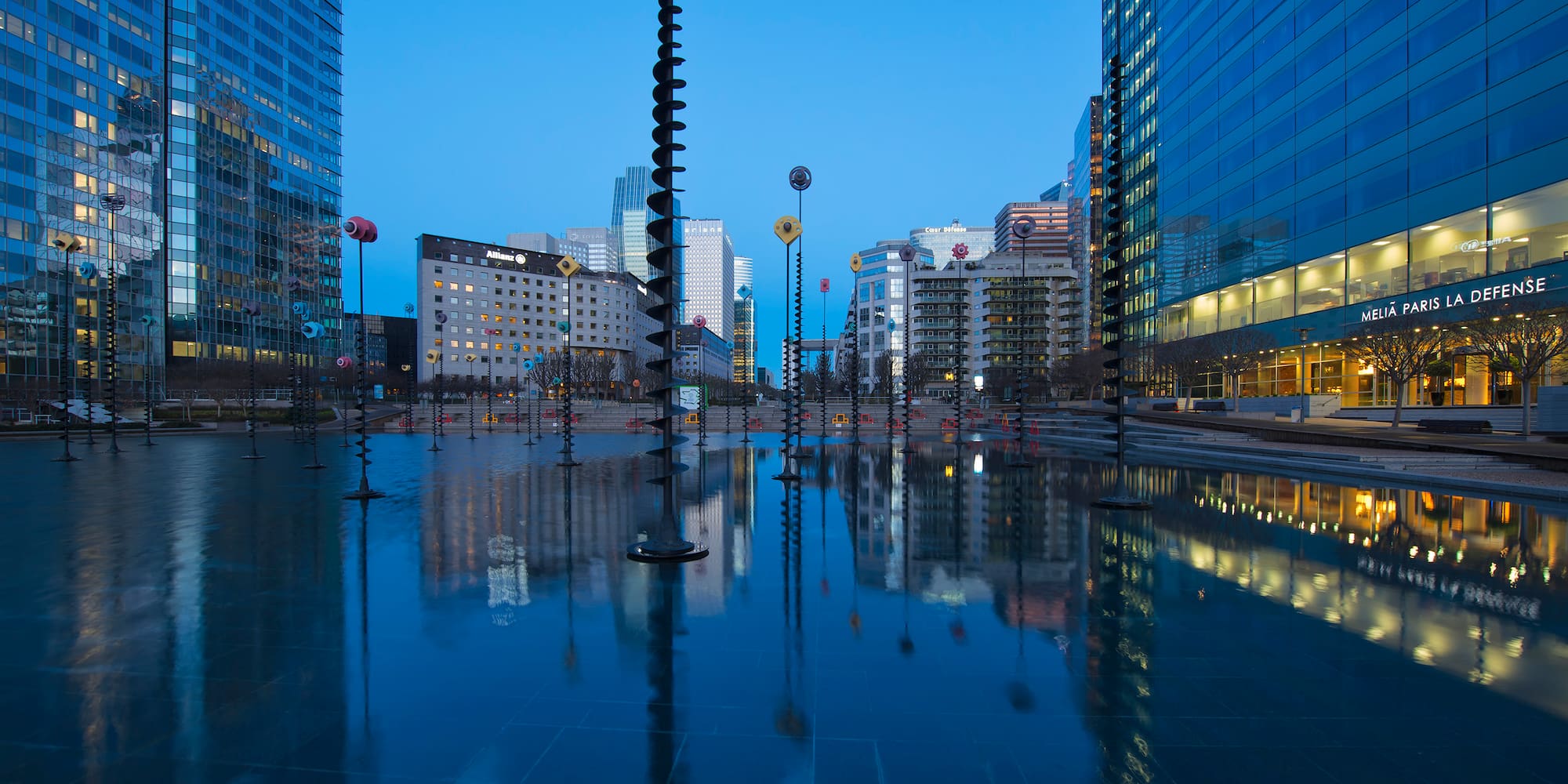 a city with tall buildings and a pool of water