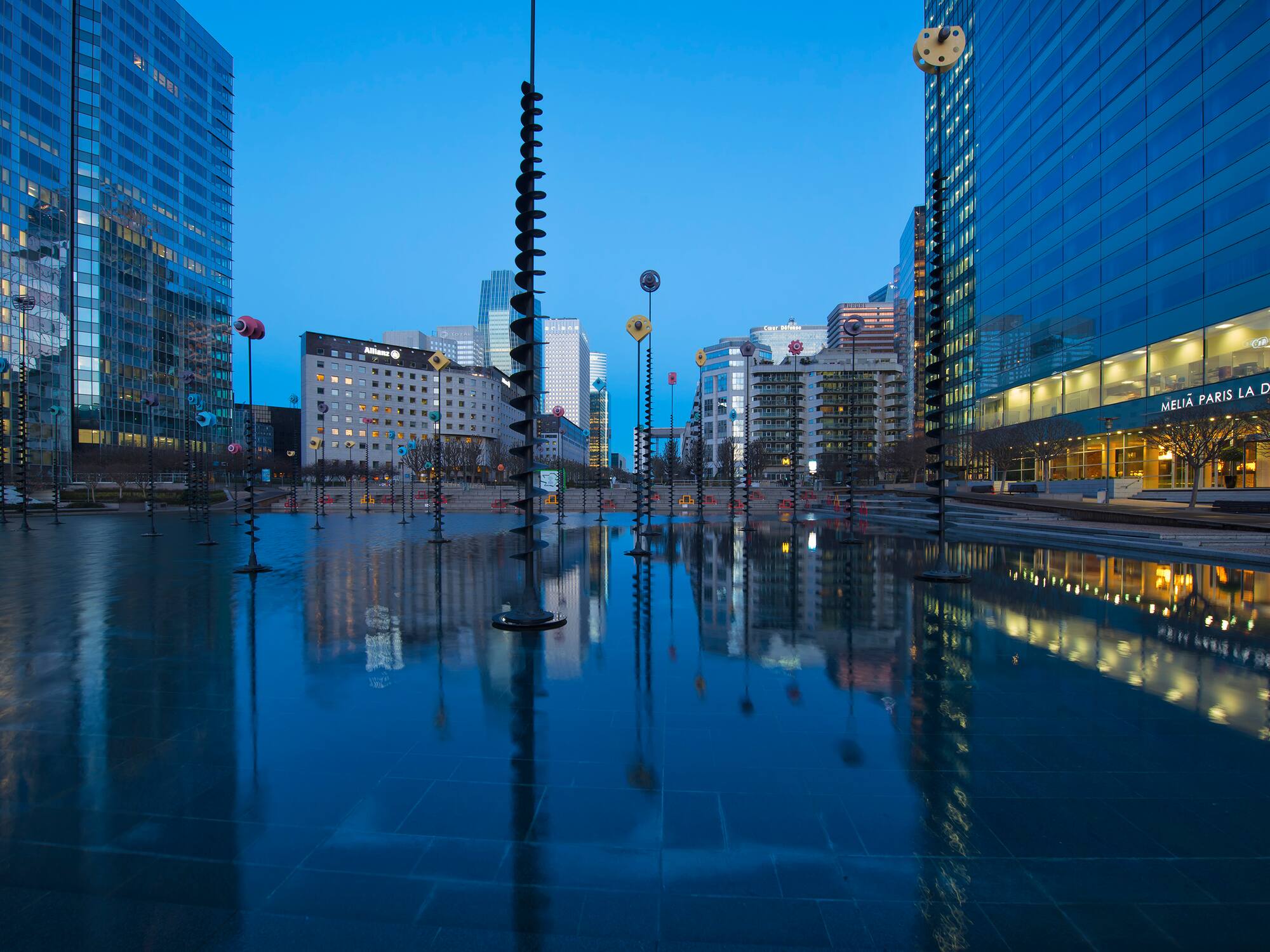 a city with tall buildings and a pool of water