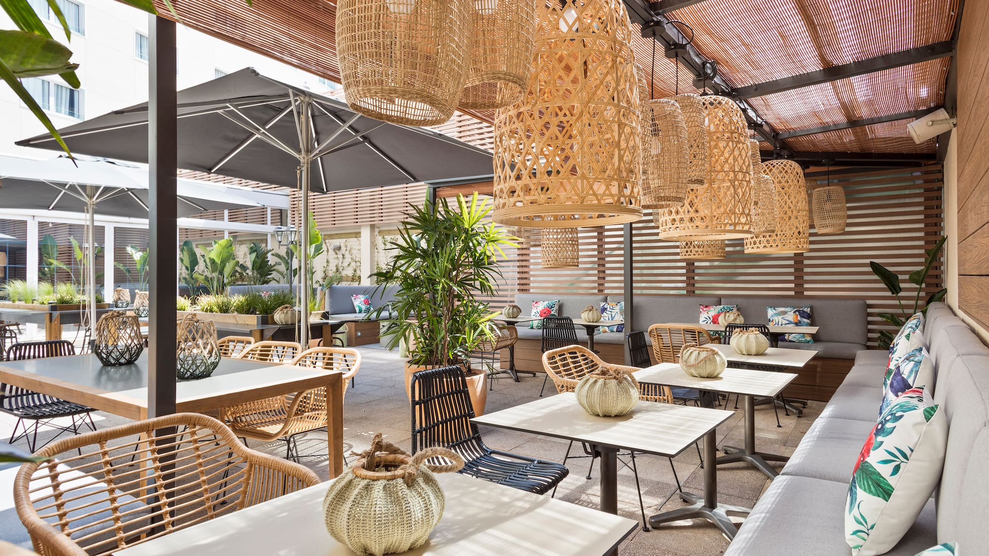 a patio with tables and chairs and umbrellas