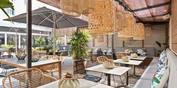 a patio with tables and chairs and umbrellas