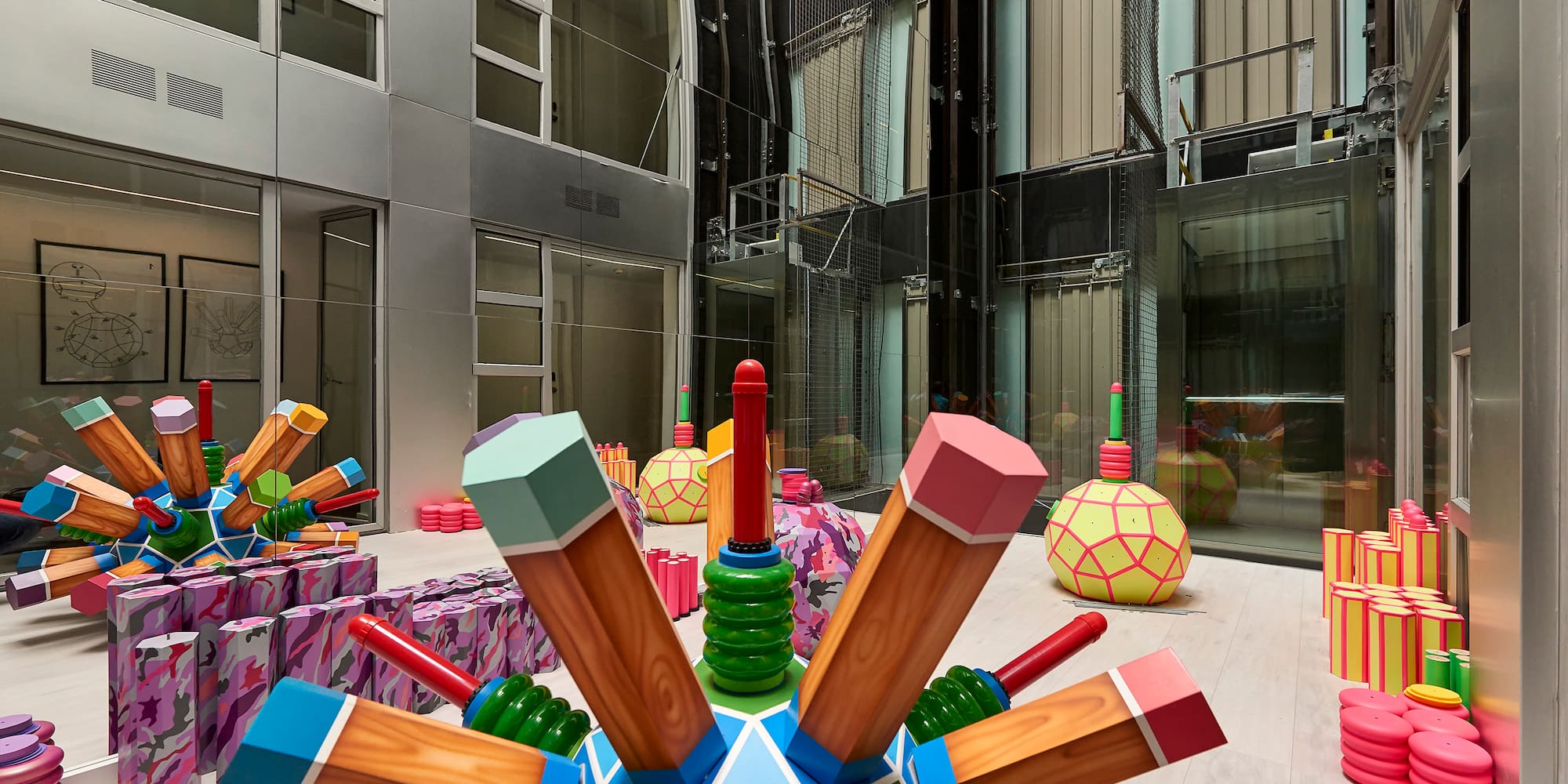 a large colorful object with wooden pencils