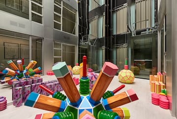 a large colorful object with wooden pencils