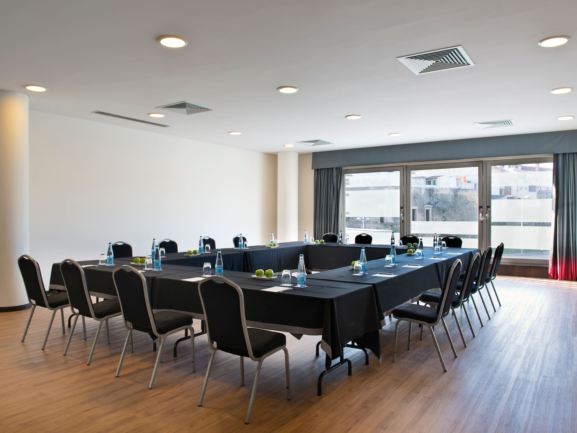 a room with a long table and chairs