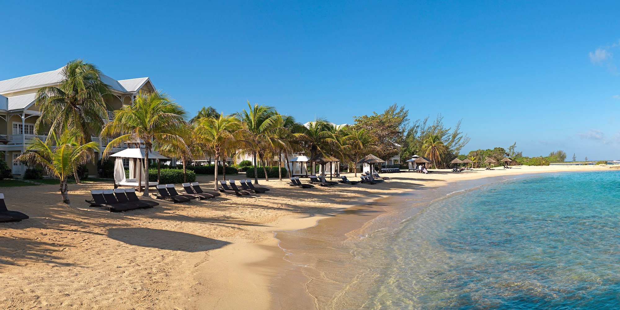 a beach with chairs and umbrellas