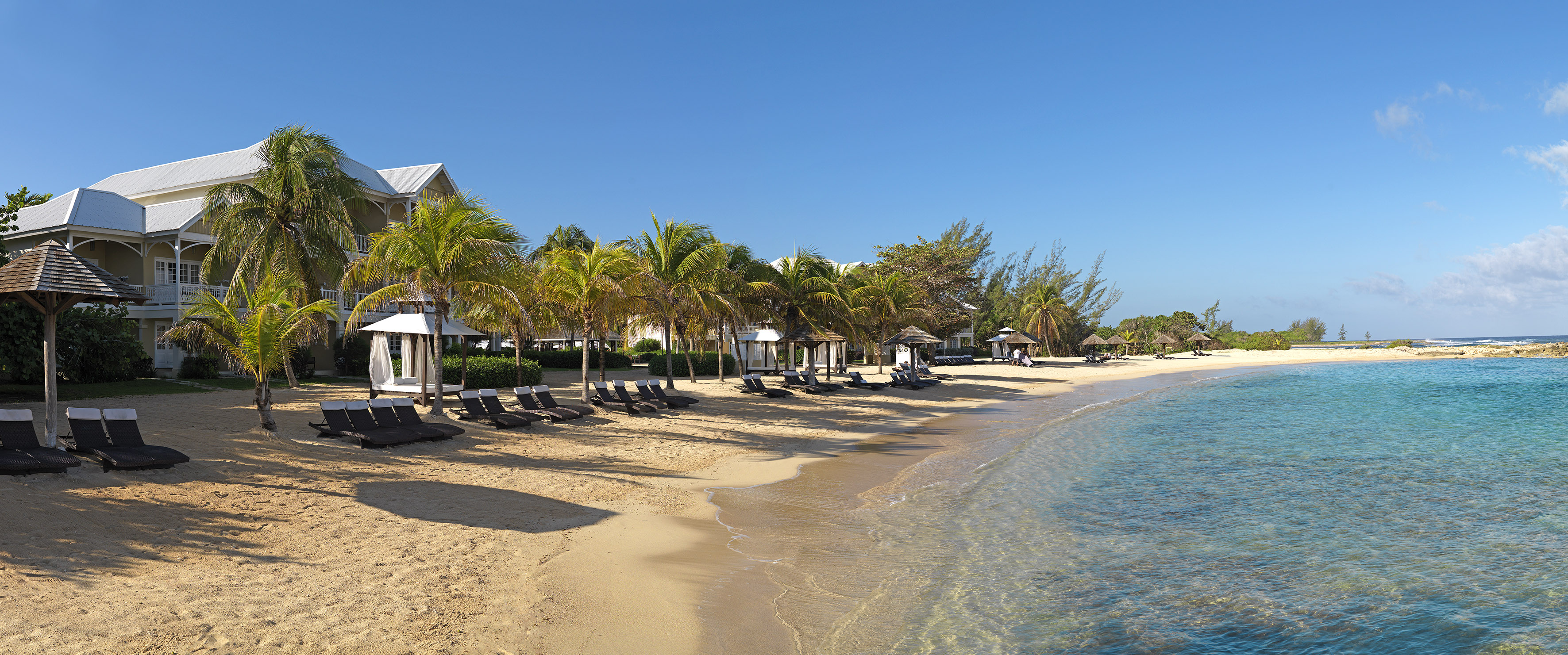 a beach with chairs and umbrellas