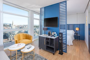 a room with a tv and a blue wall