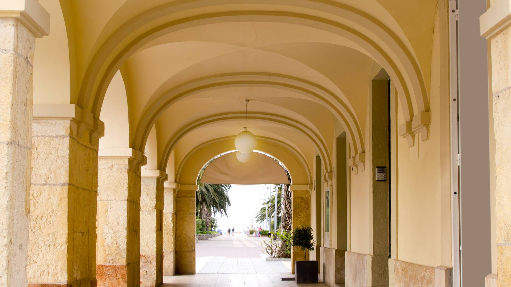 a hallway with arched ceiling and light fixtures