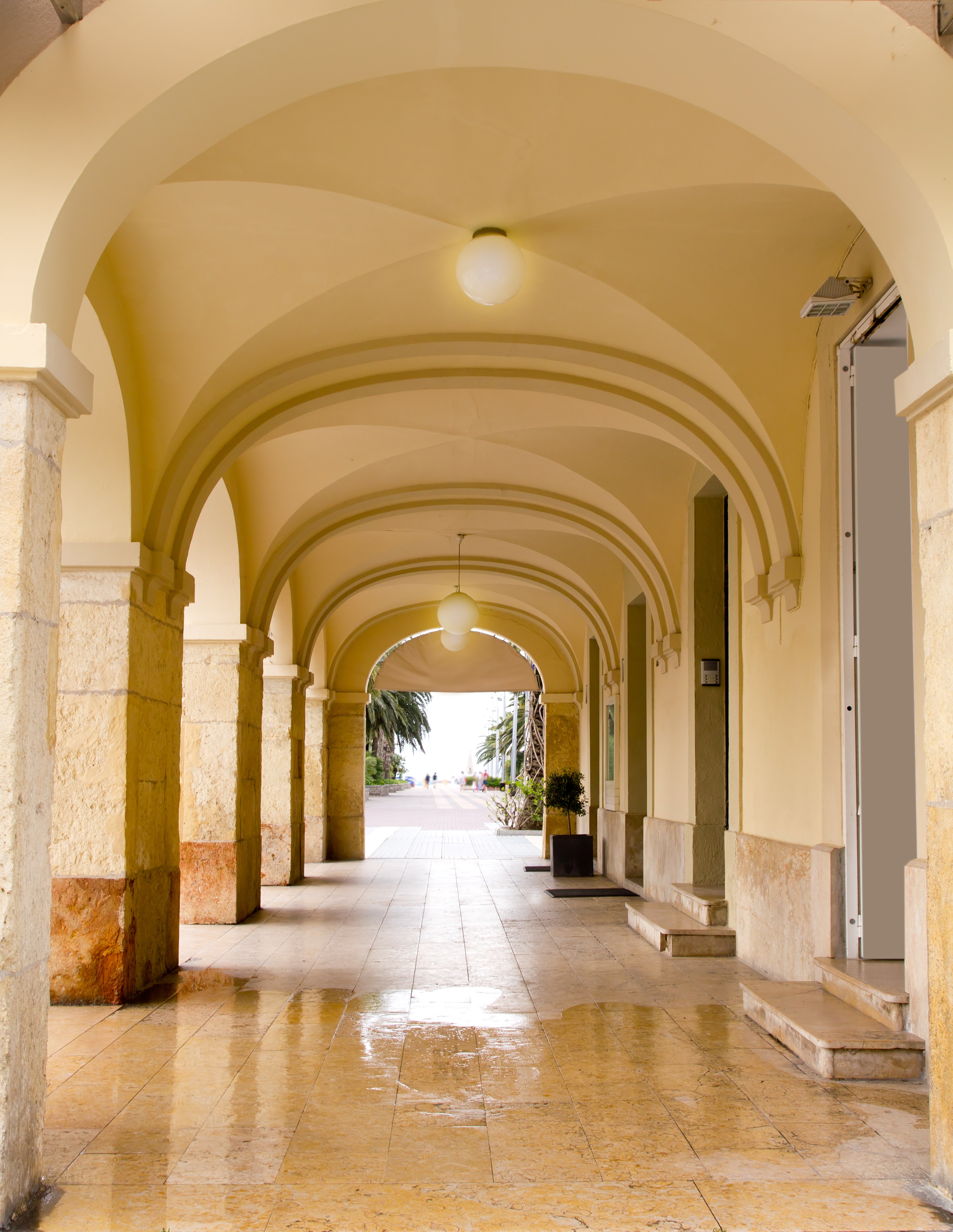 a hallway with arched ceiling and light fixtures