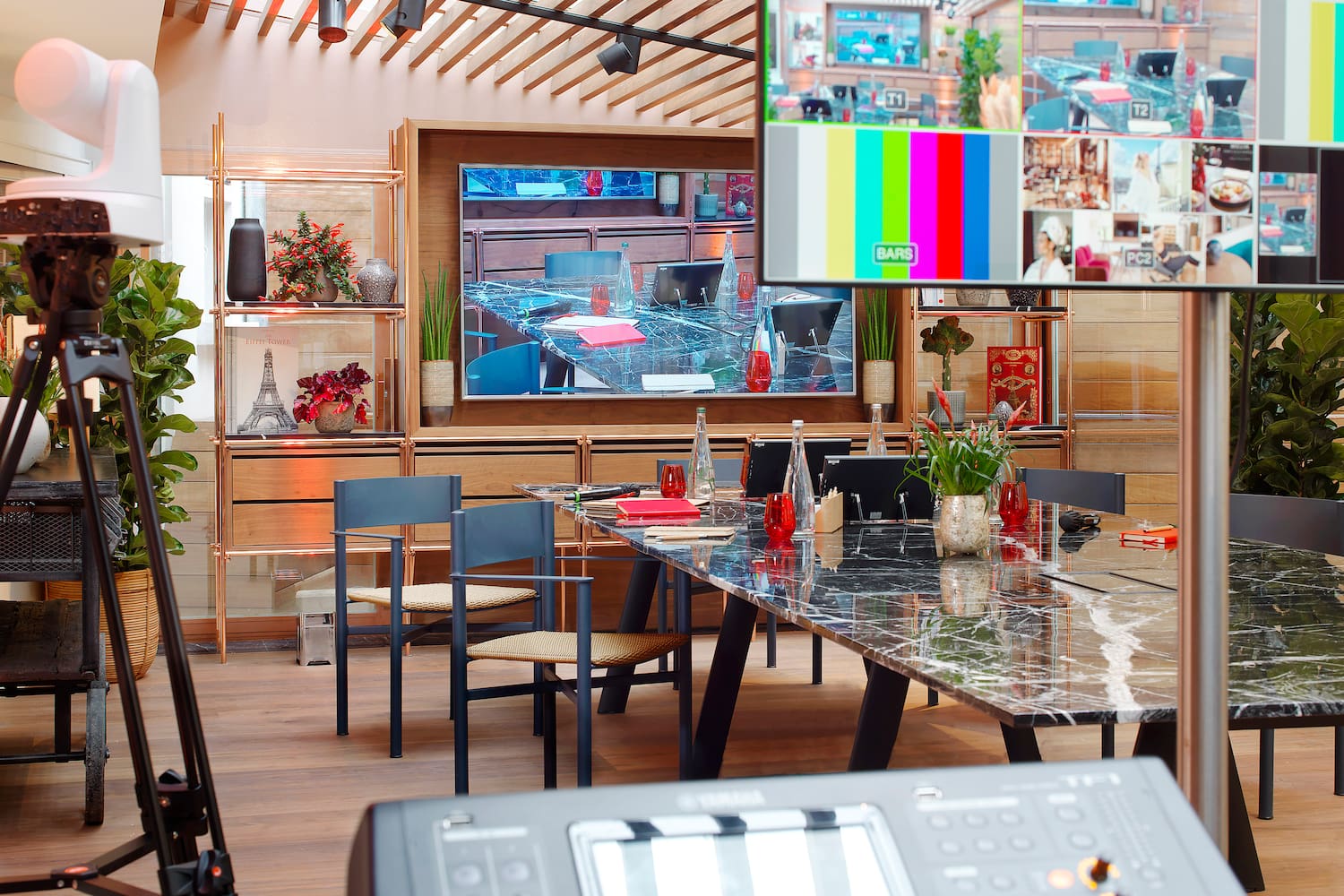 Broadcast studio: multi-feed monitor, PTZ camera, Yamaha mixer, meeting room.