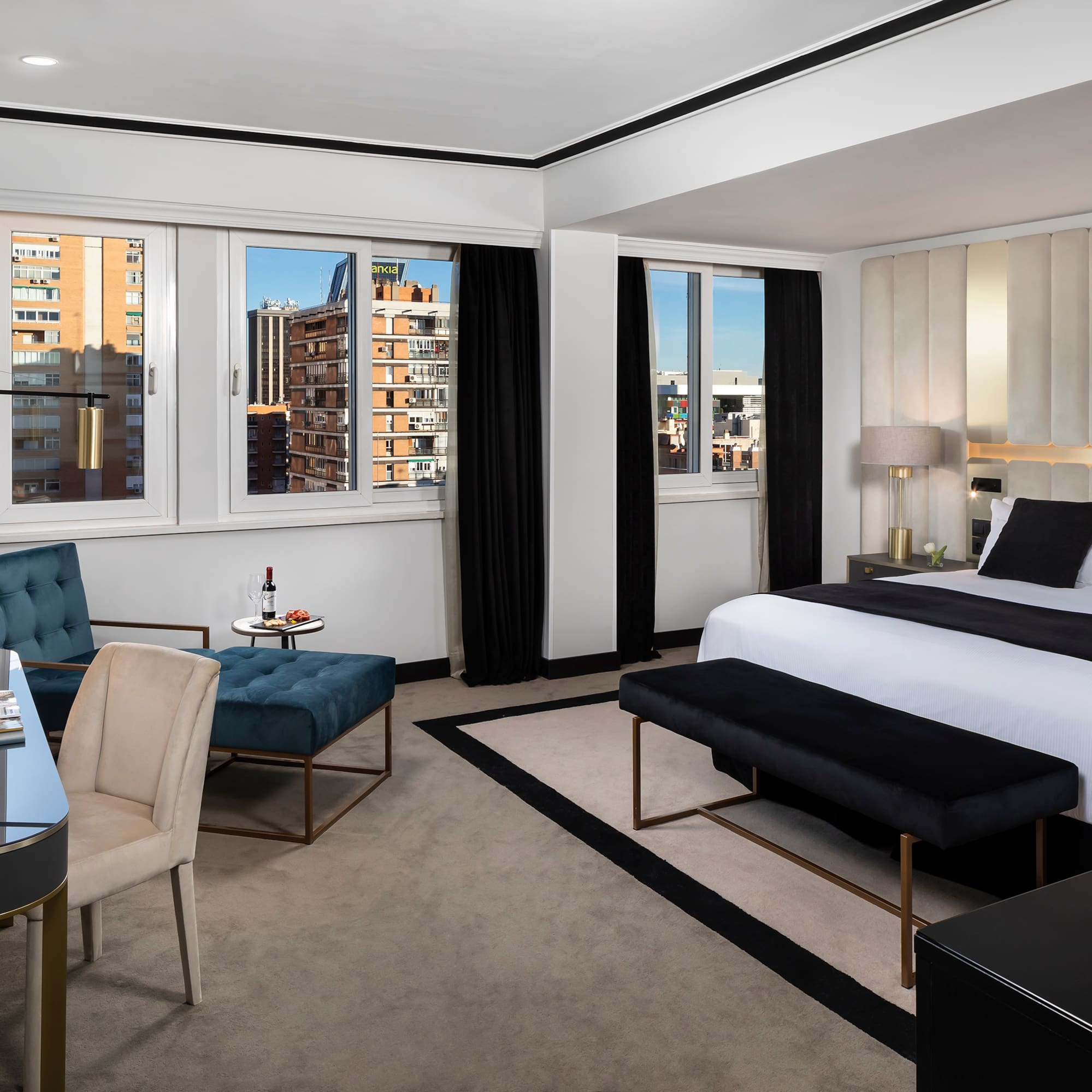 a room with a bed and chairs