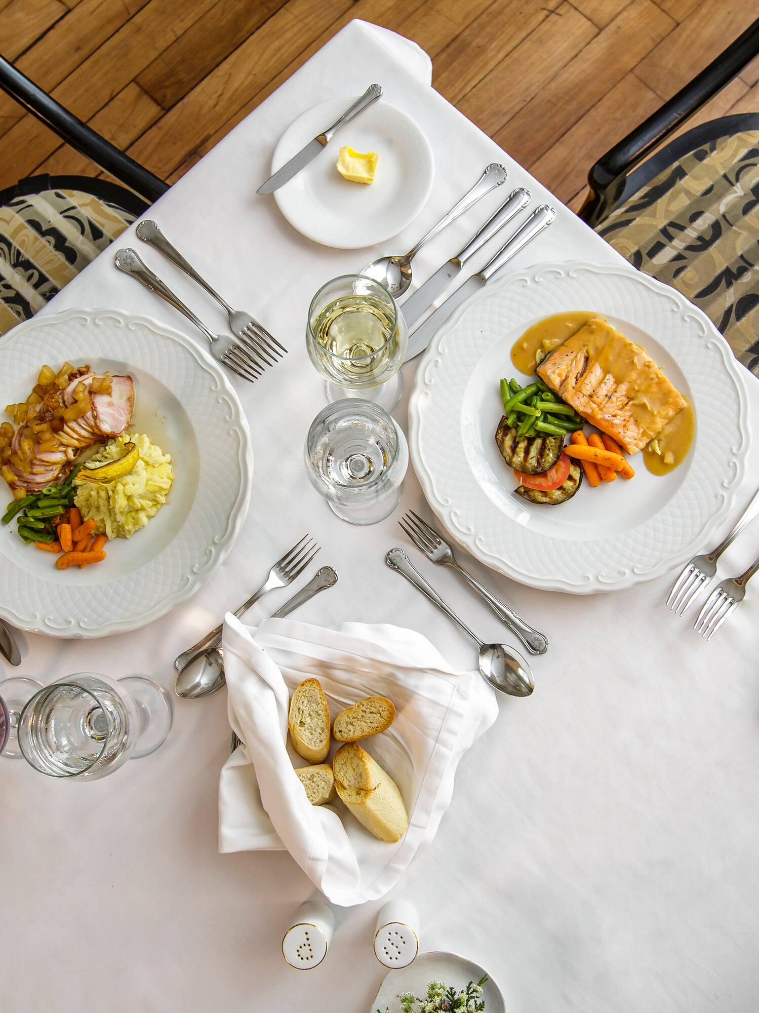 a table with plates of food and glasses