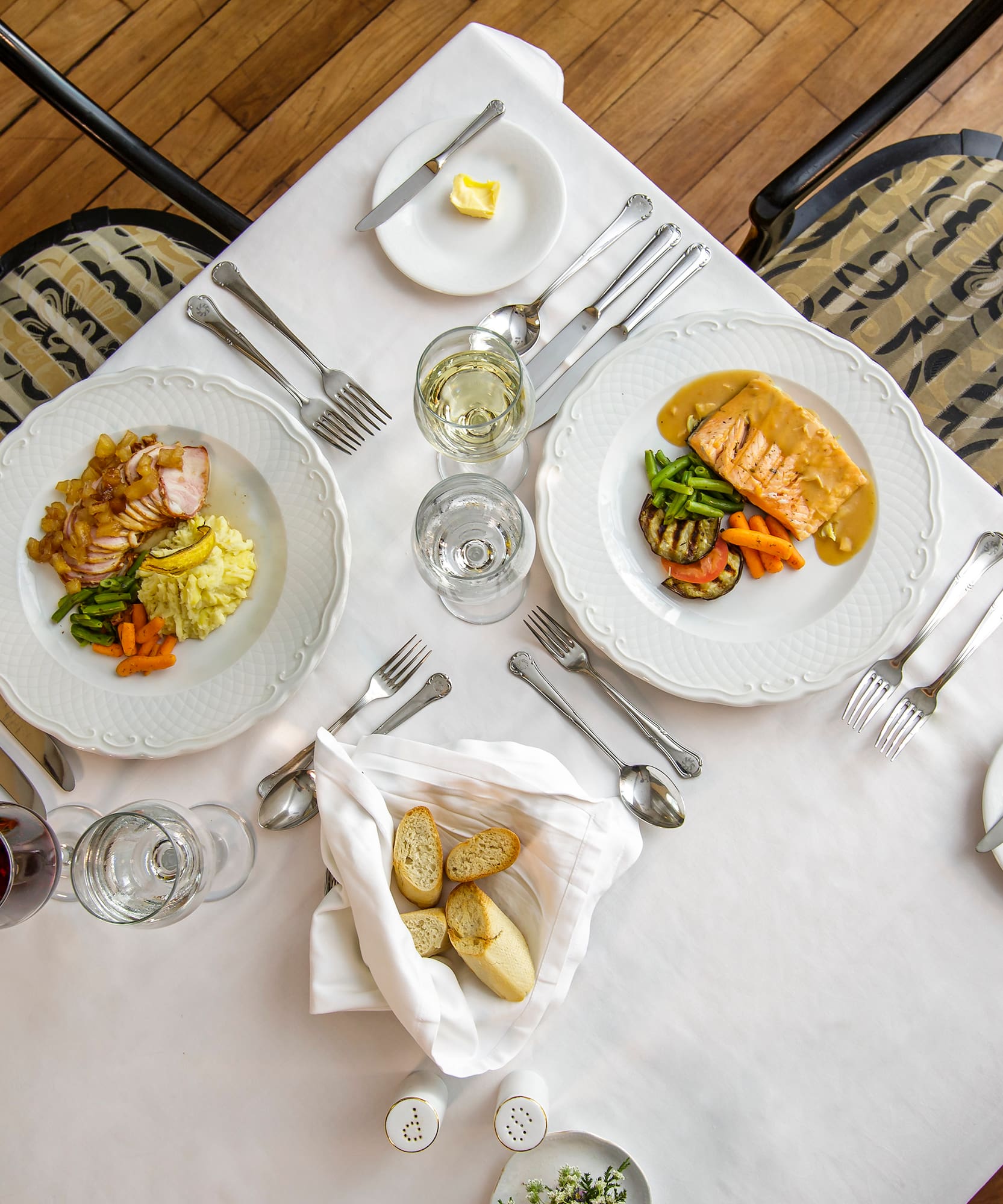 a table with plates of food and glasses