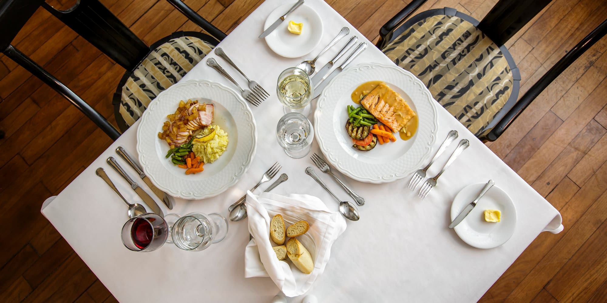 a table with plates of food and glasses