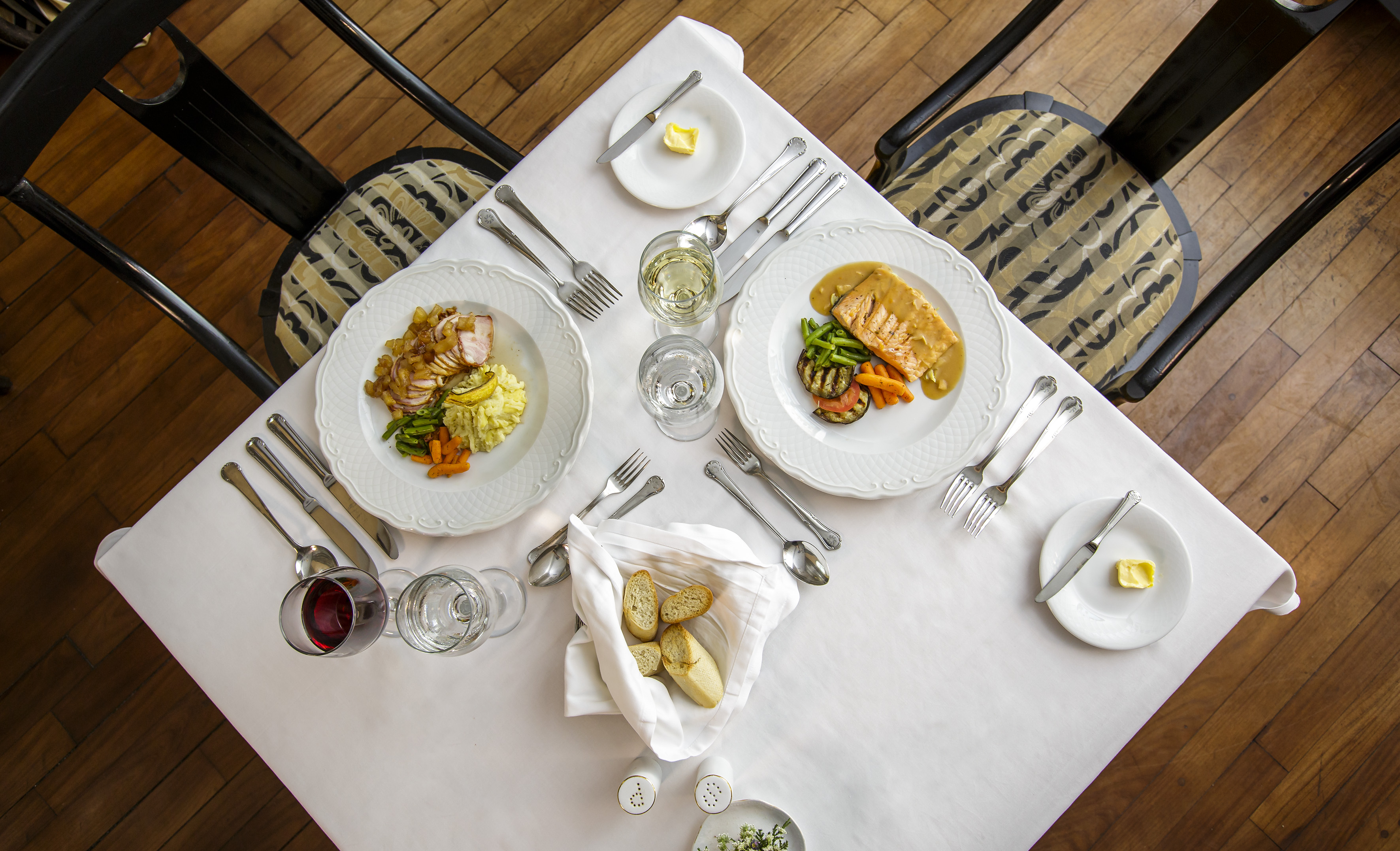 a table with plates of food and glasses