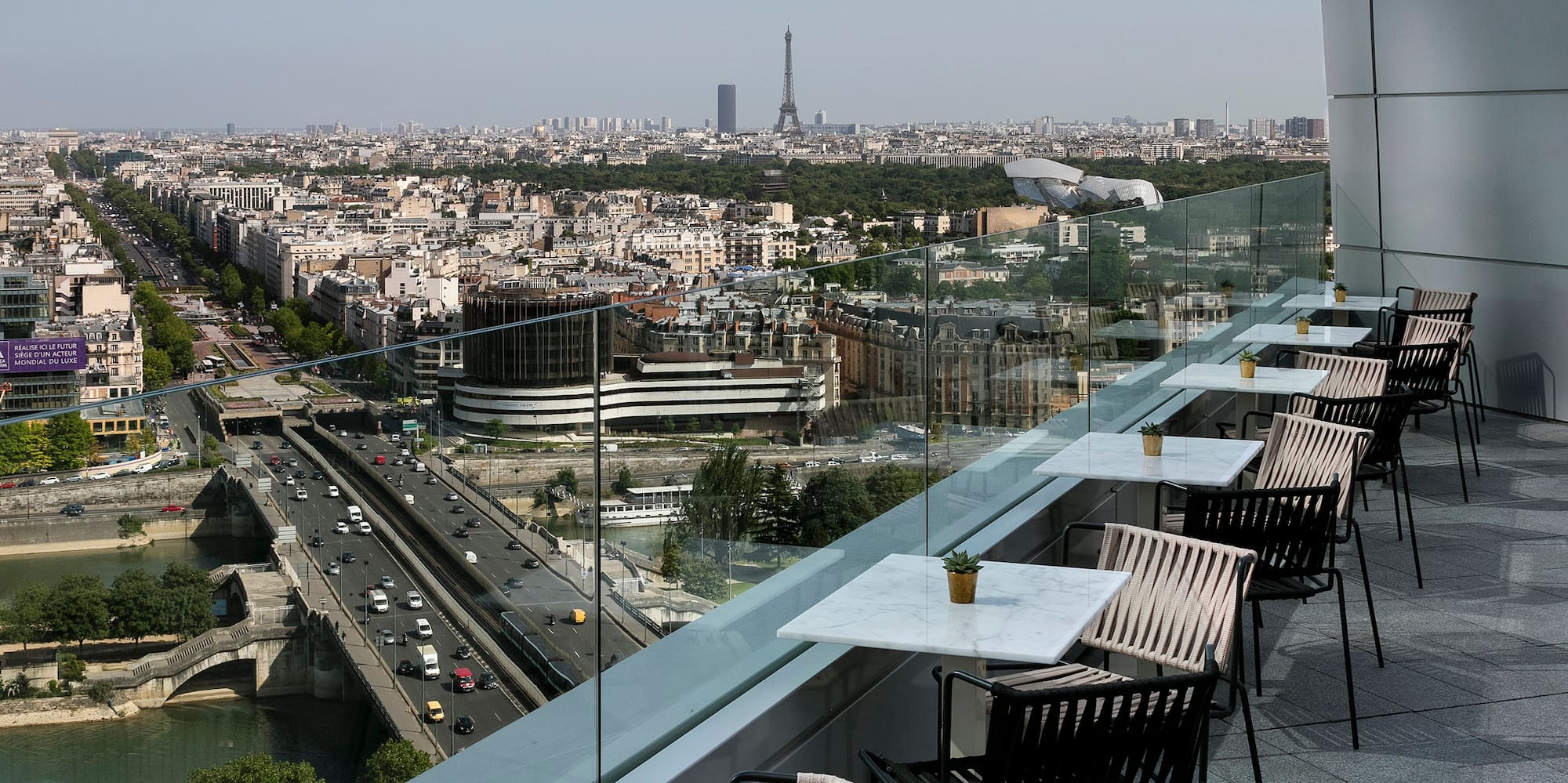 a balcony with tables and chairs on it