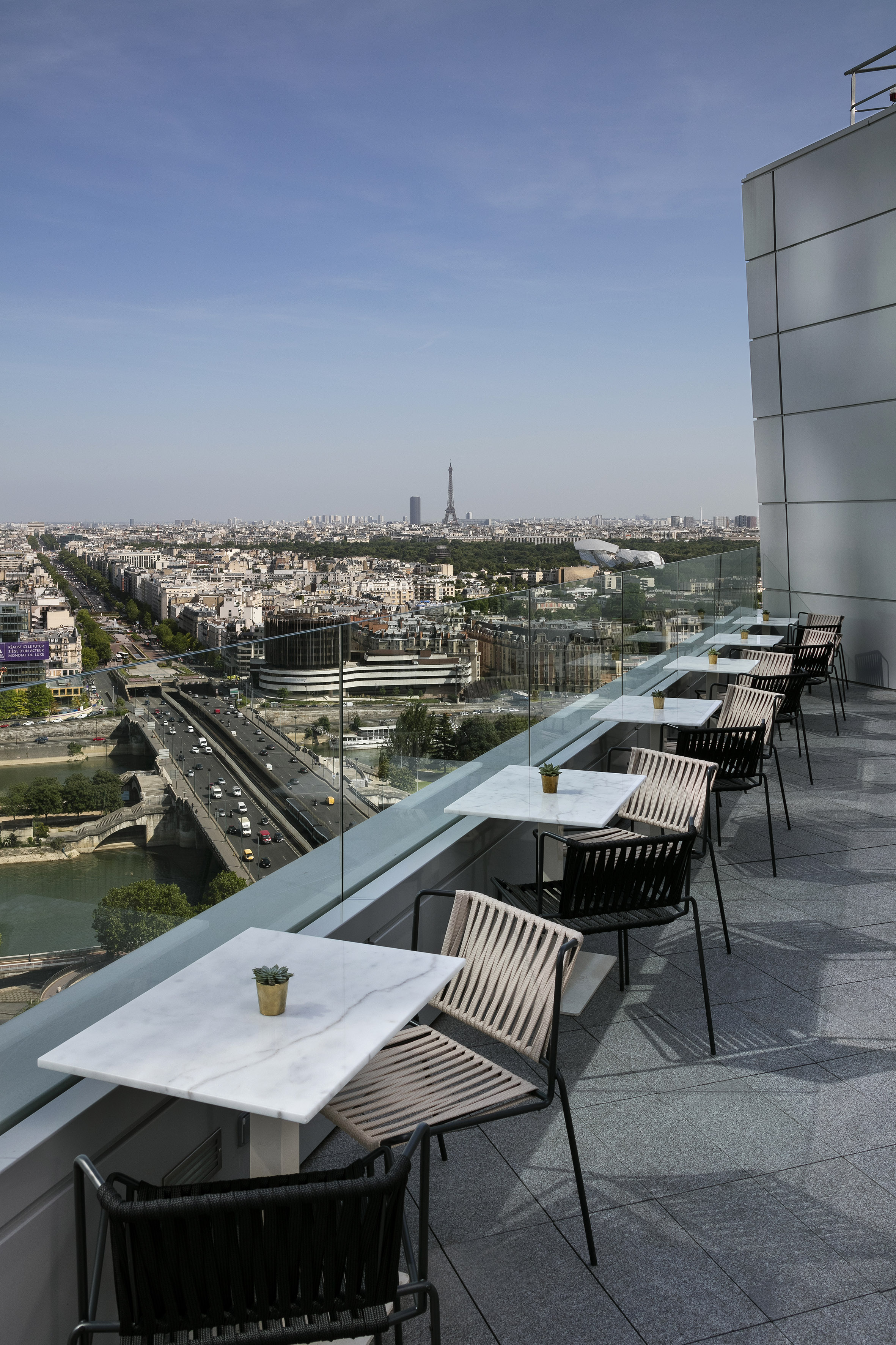 a balcony with tables and chairs on it
