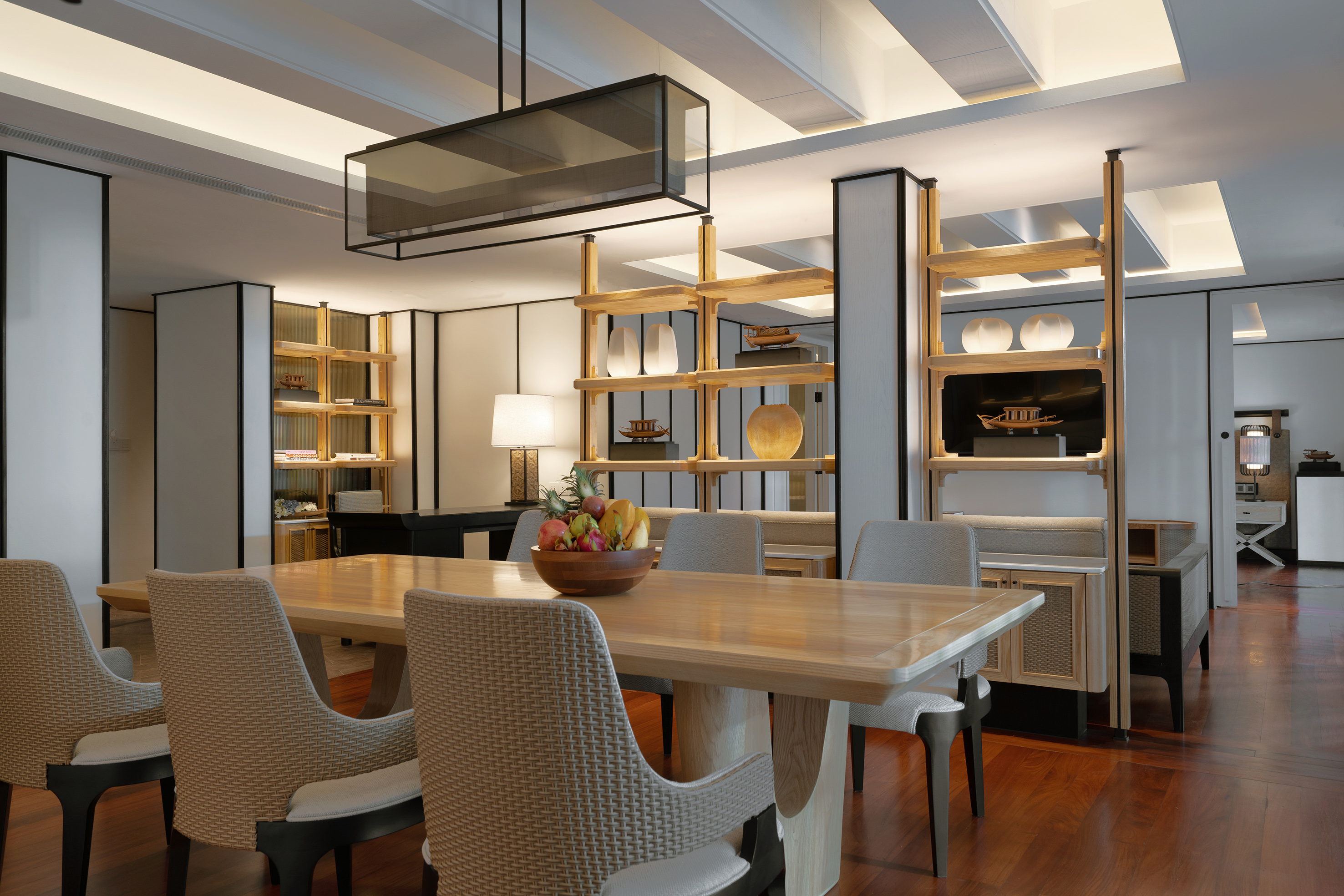 Elegant modern dining room with large wooden table, chandelier, and Asian accents.