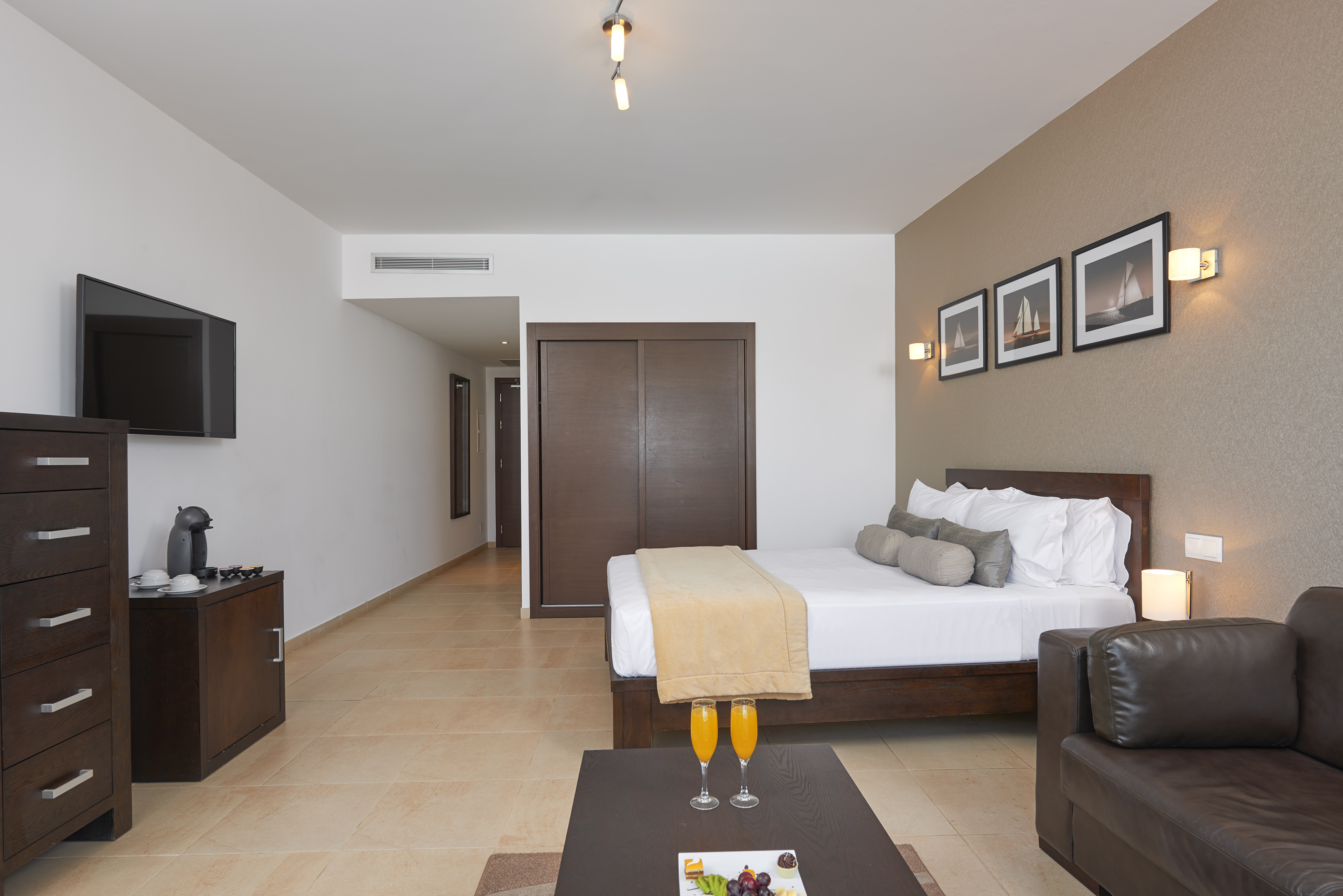 a room with a bed and a coffee table