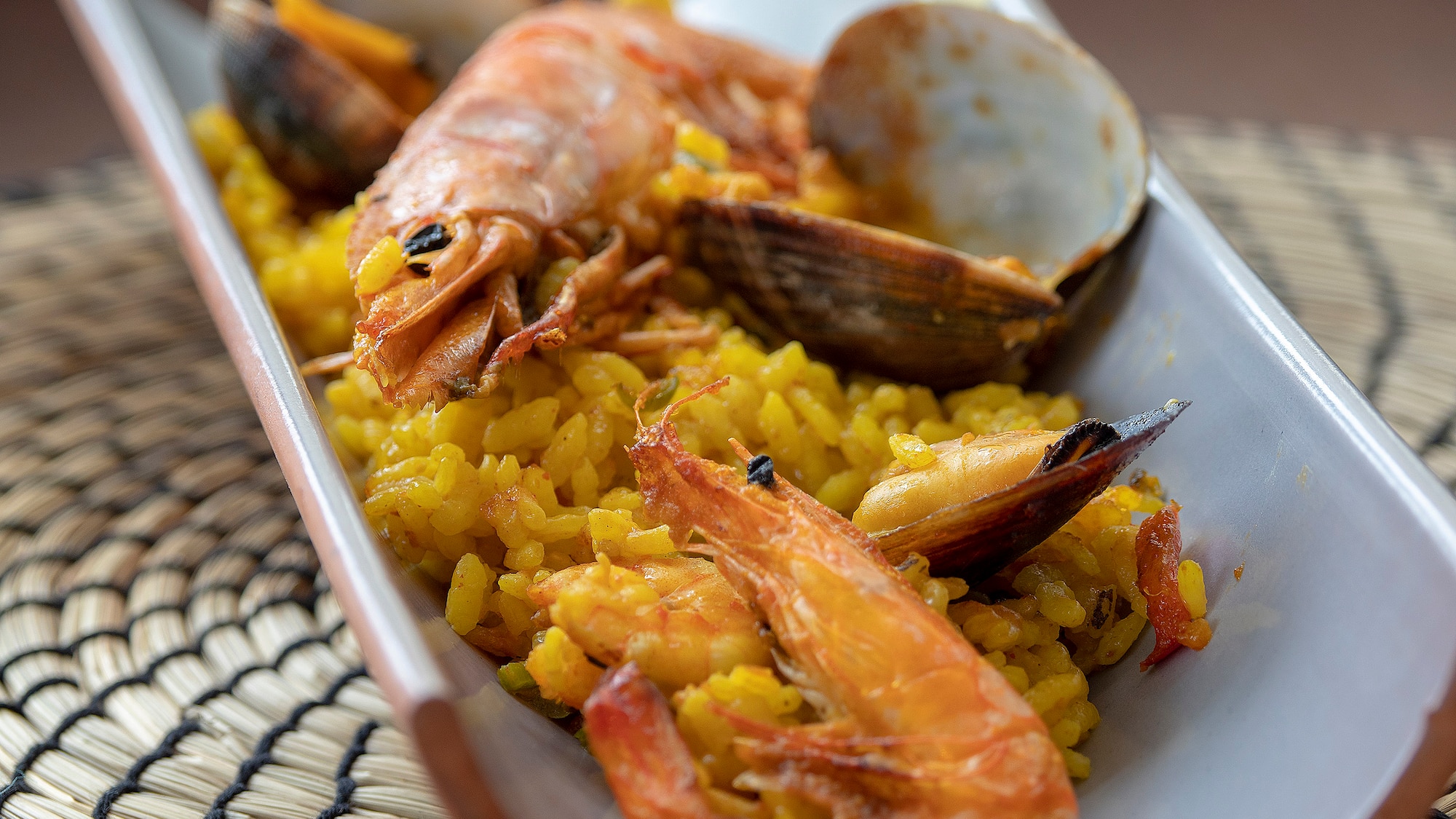 a plate of rice with shrimp and clams