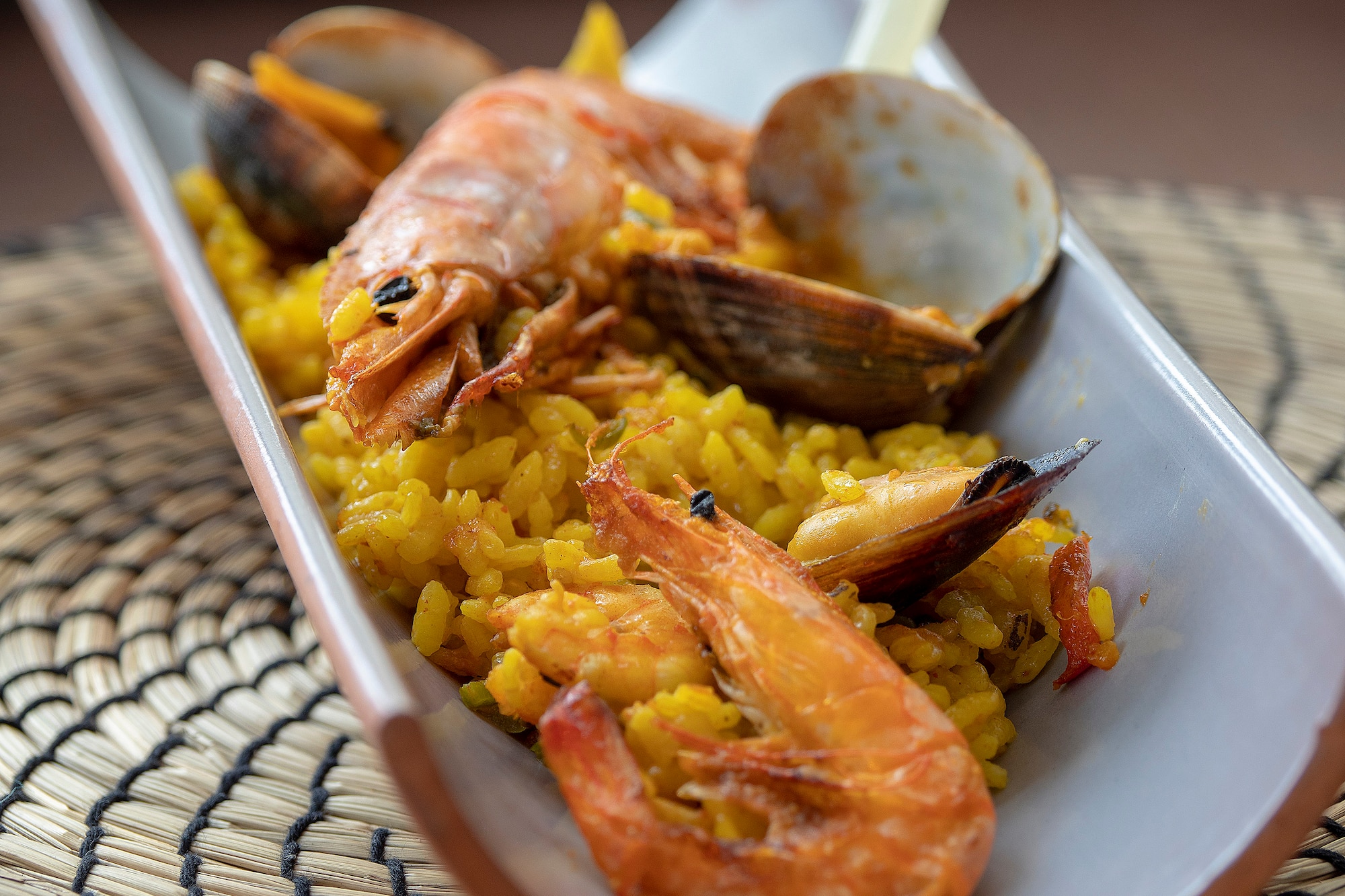 a plate of rice with shrimp and clams