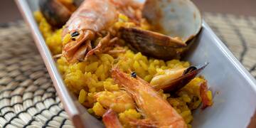 a plate of rice with shrimp and clams
