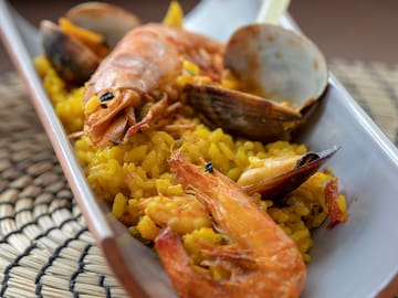 a plate of rice with shrimp and clams