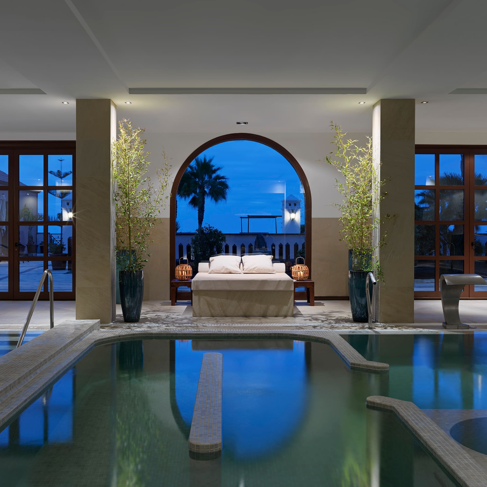 a indoor pool with a bed and a bed in it