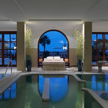 a indoor pool with a bed and a bed in it