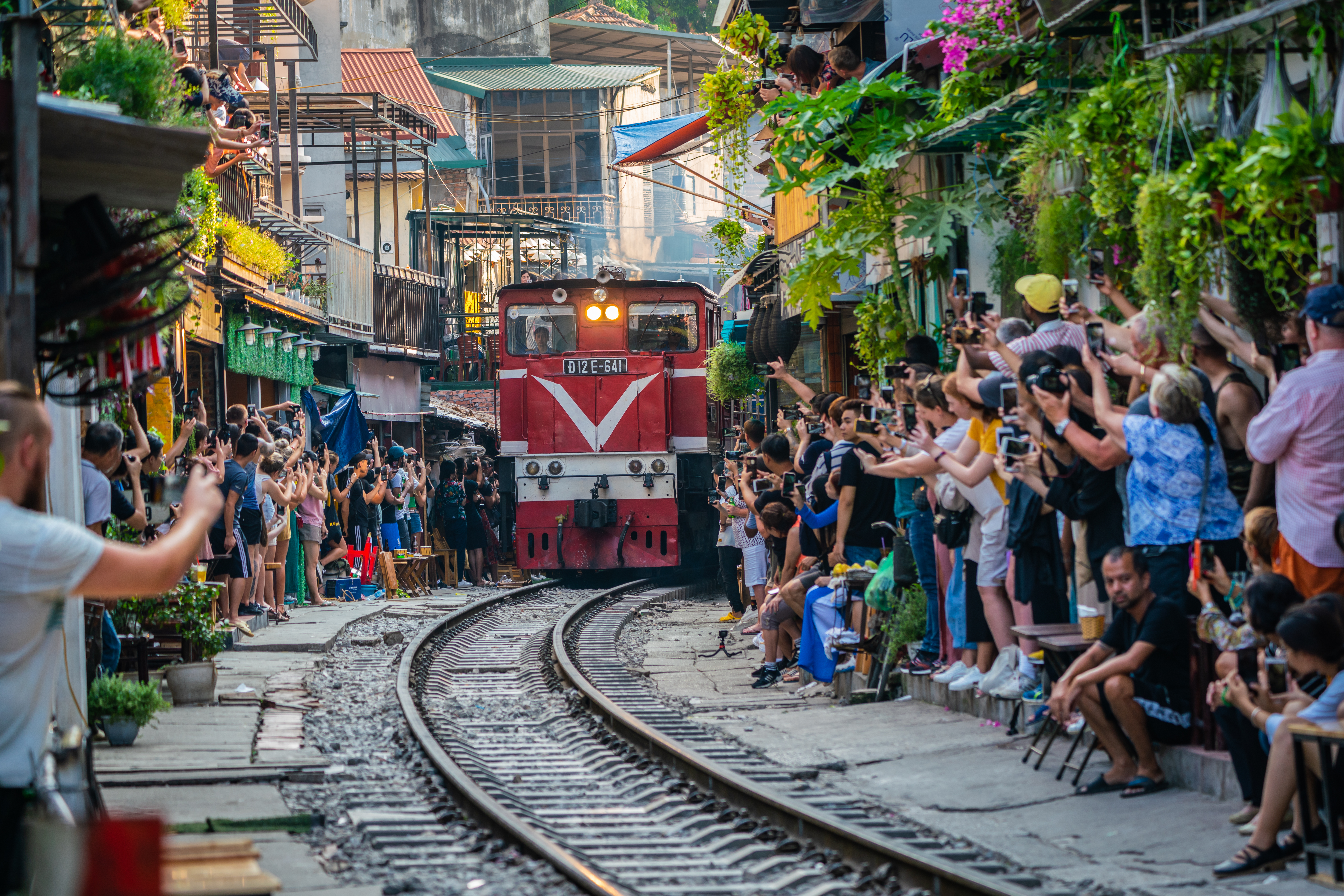 a train going down the tracks with people watching