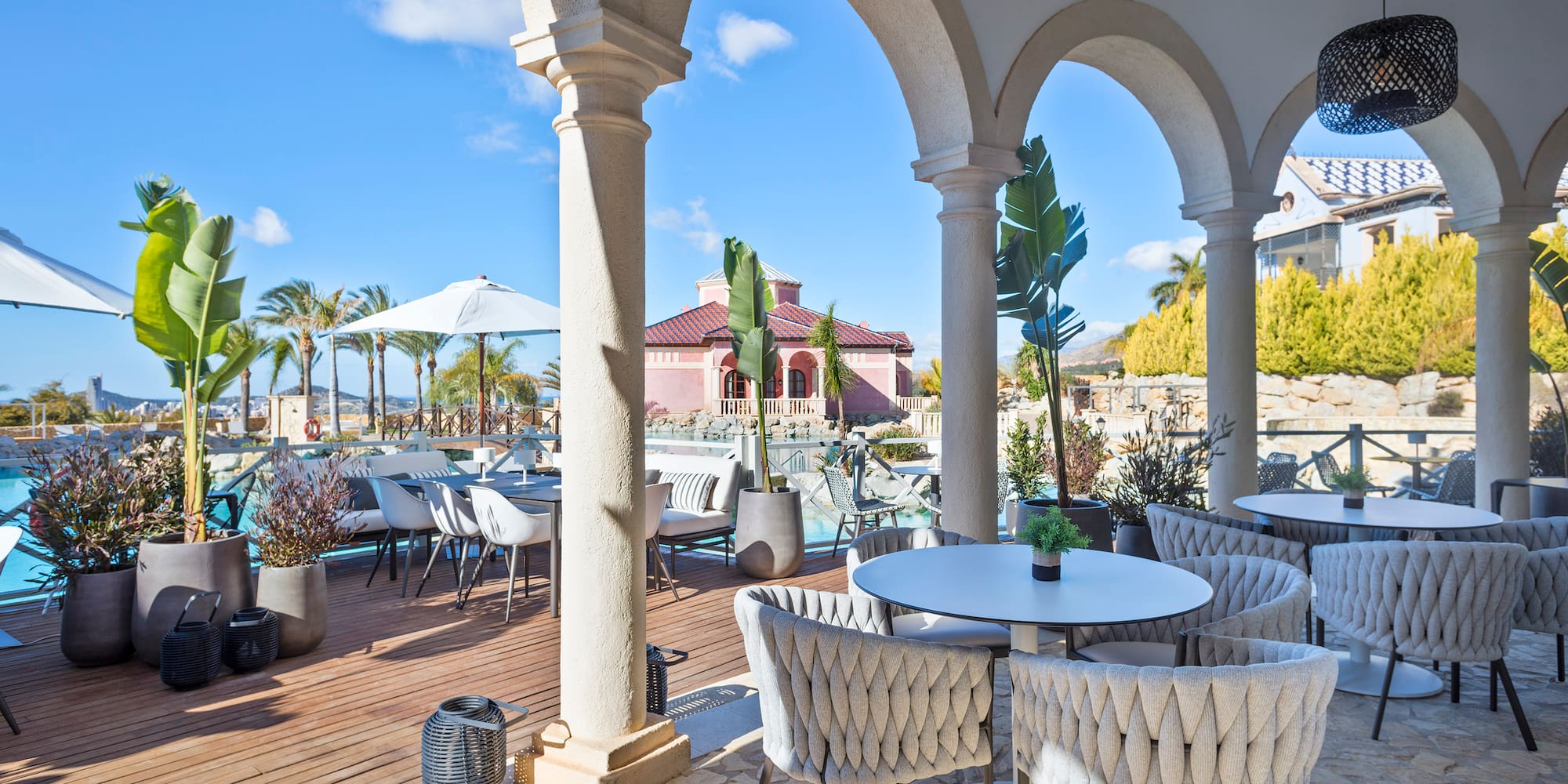 a patio with tables and chairs