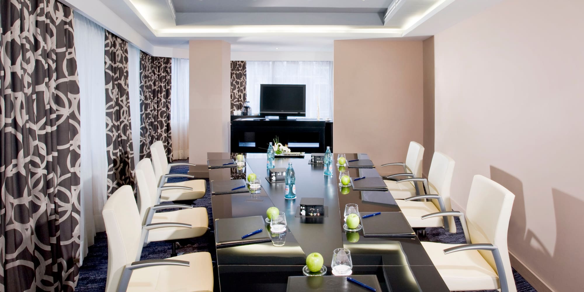 a conference room with a table and chairs