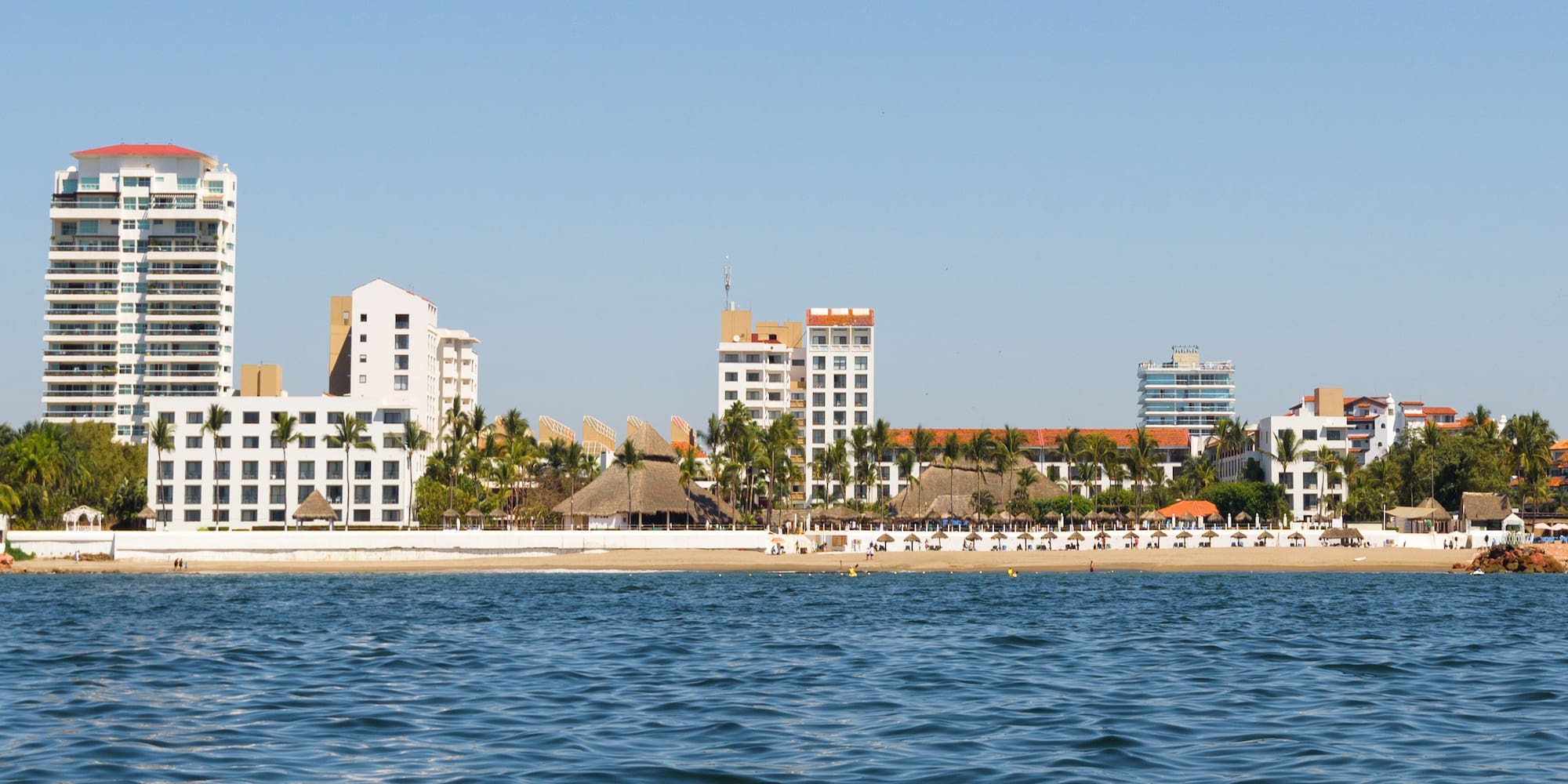 a body of water with buildings and trees