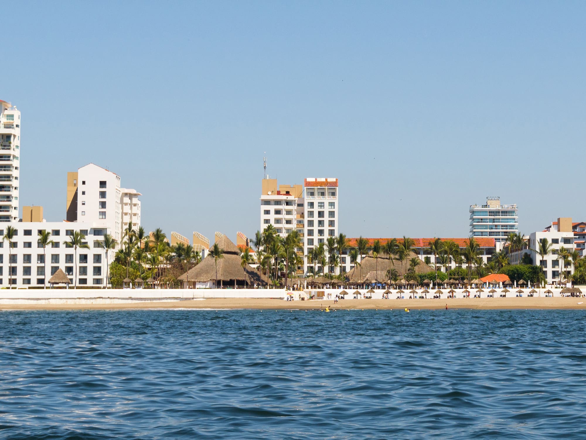 a body of water with buildings and trees