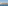 Tropical beach resort skyline from ocean with hotels, palm trees, and sandy shore.