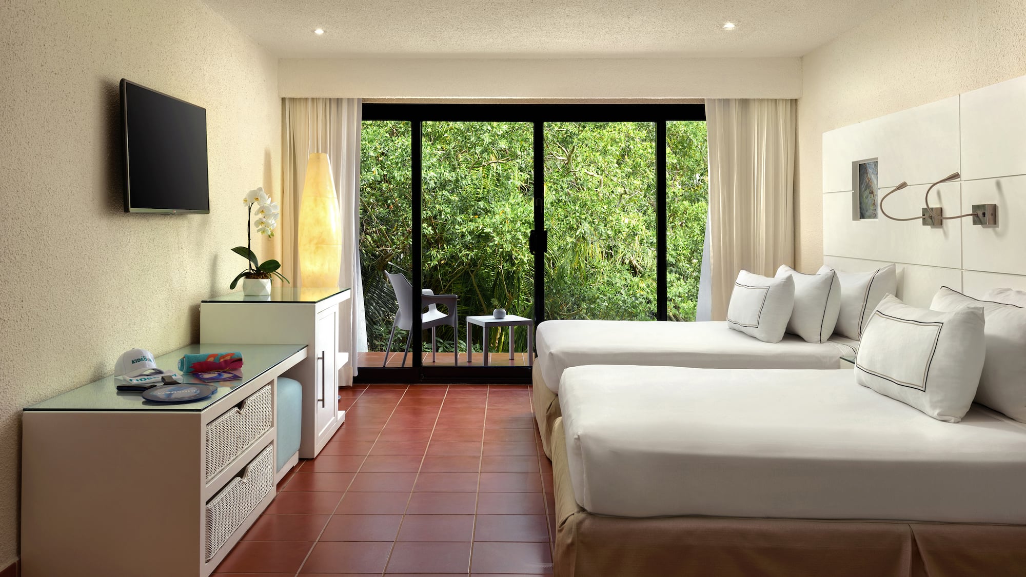 a room with two beds and a television