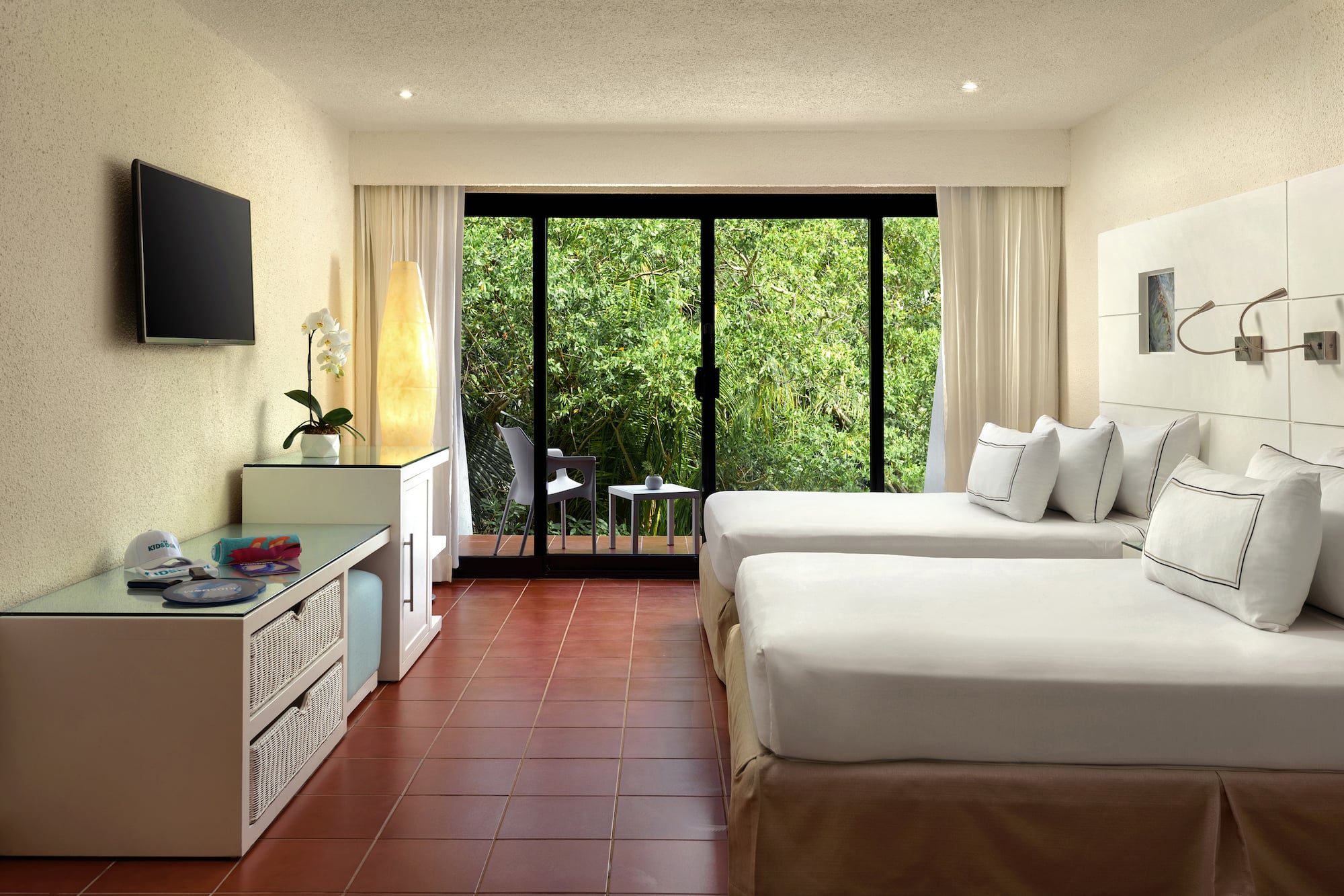 a room with two beds and a television