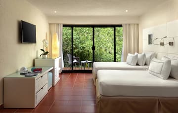 a room with two beds and a television