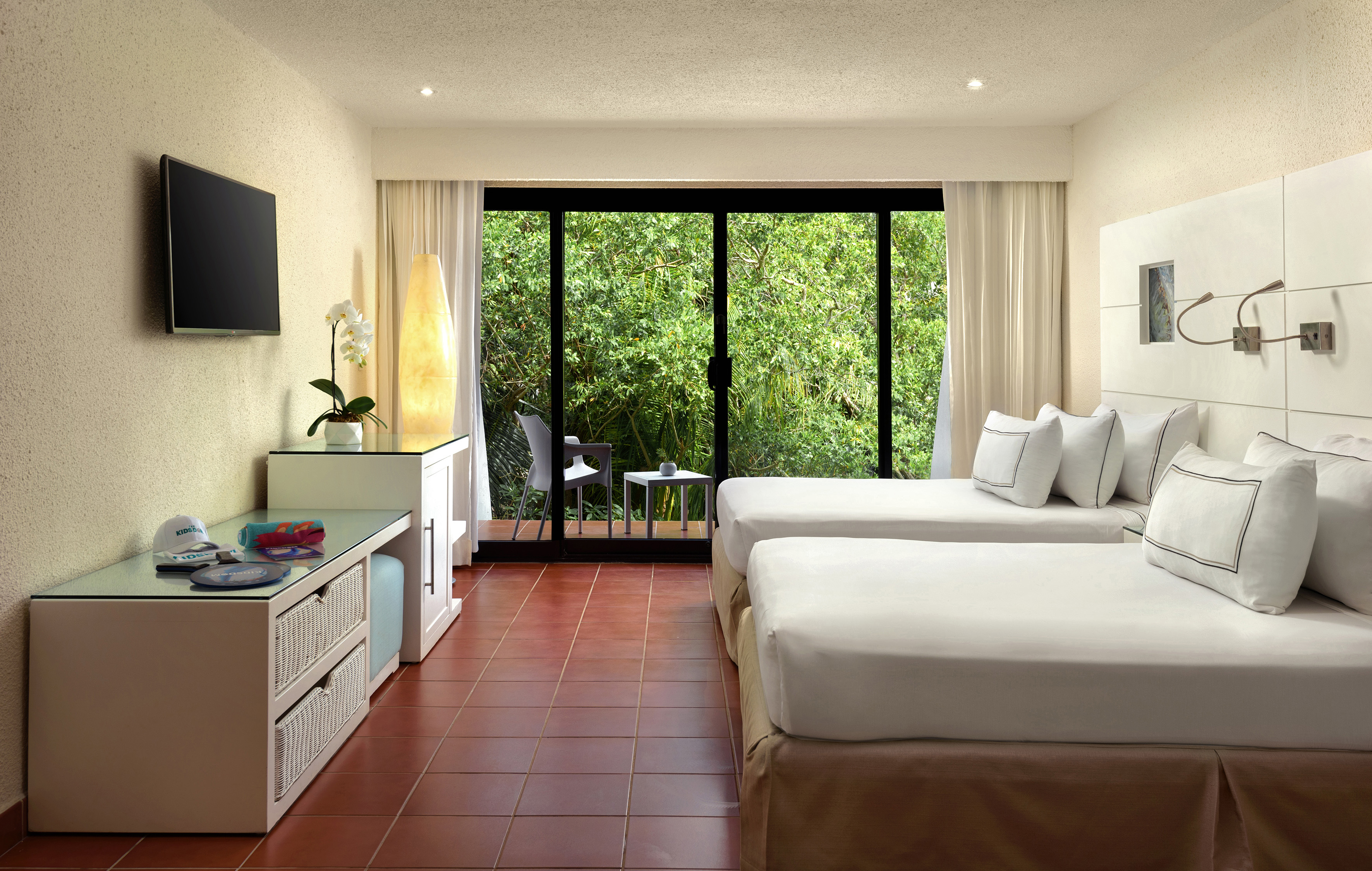 a room with two beds and a television