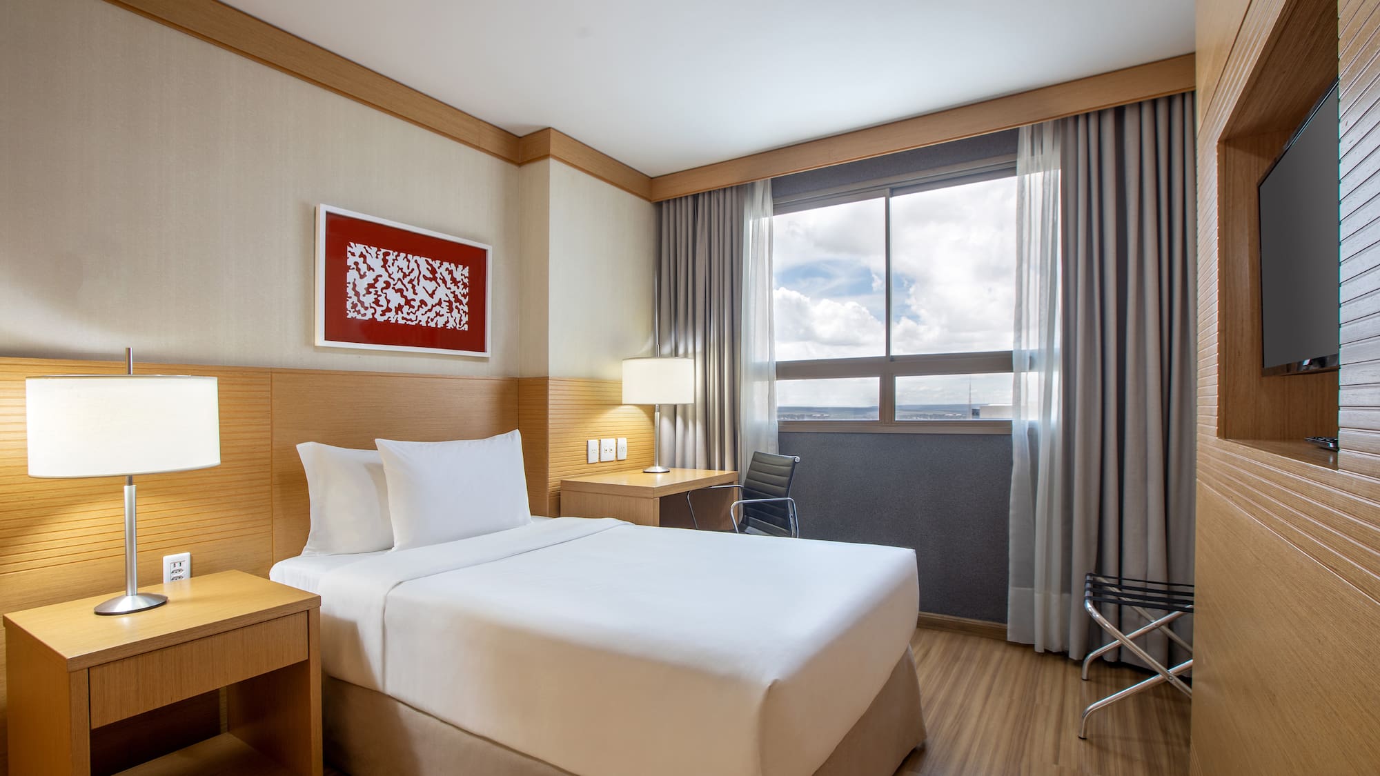 a room with a bed and a table and chair