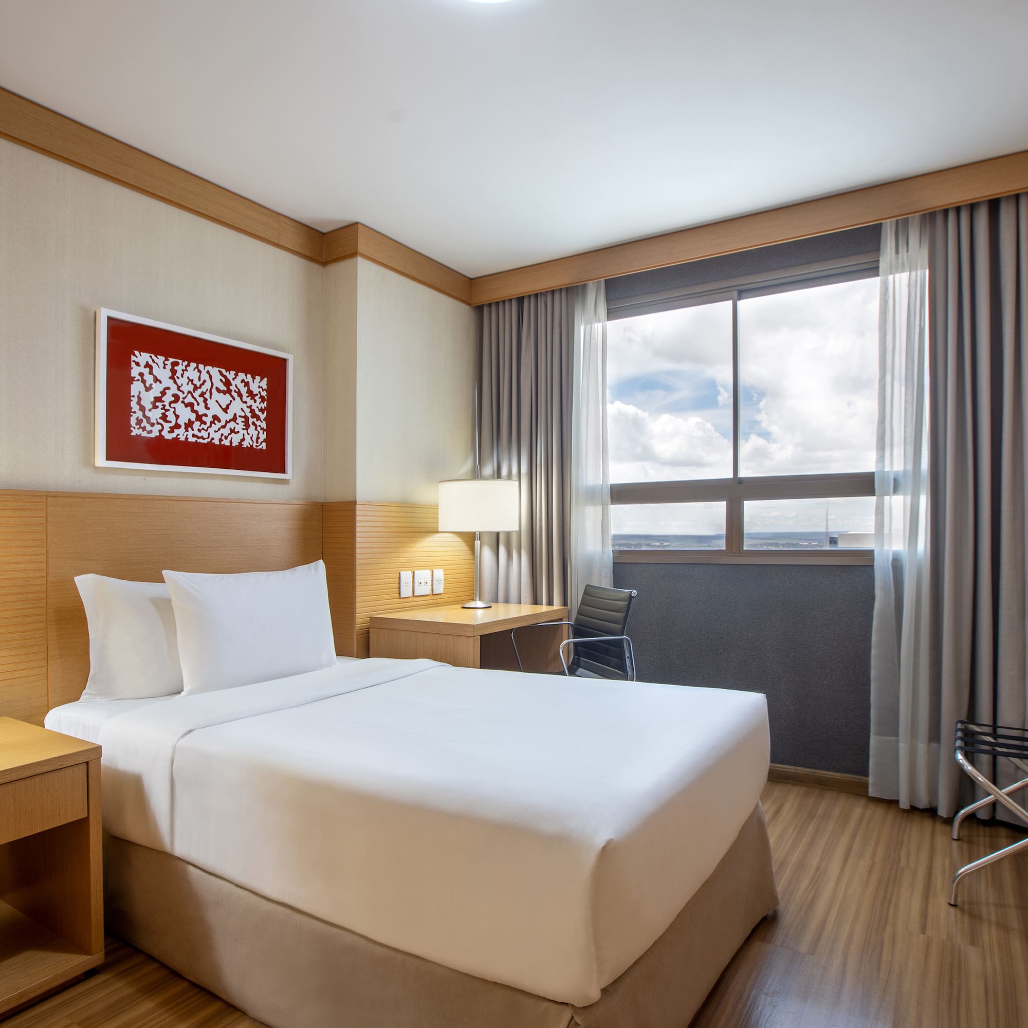 a room with a bed and a table and chair