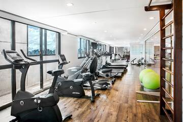 a room with exercise equipment and a window
